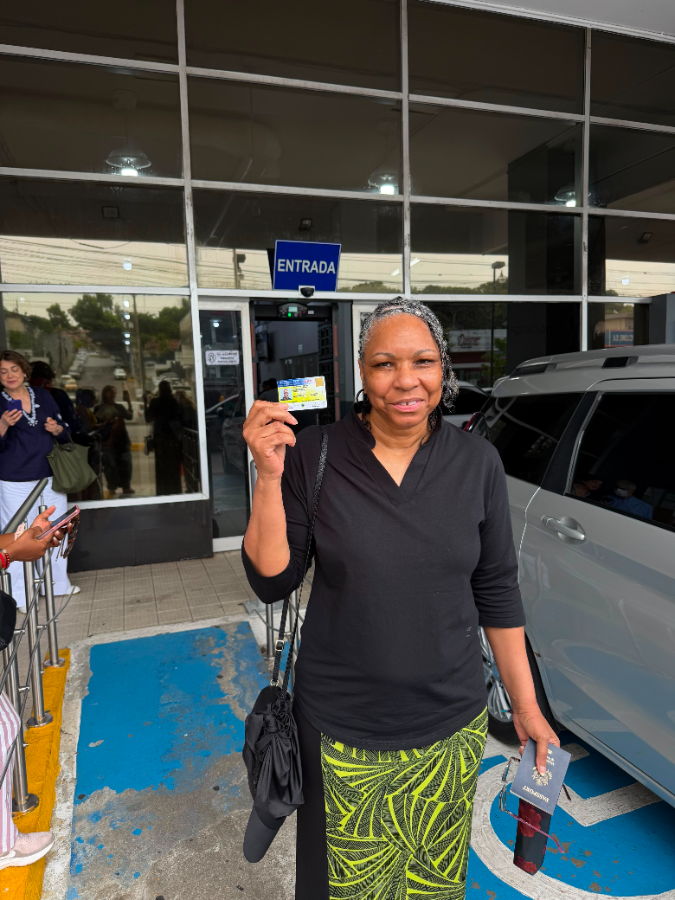 A veteran holding her new Panamanian ID card