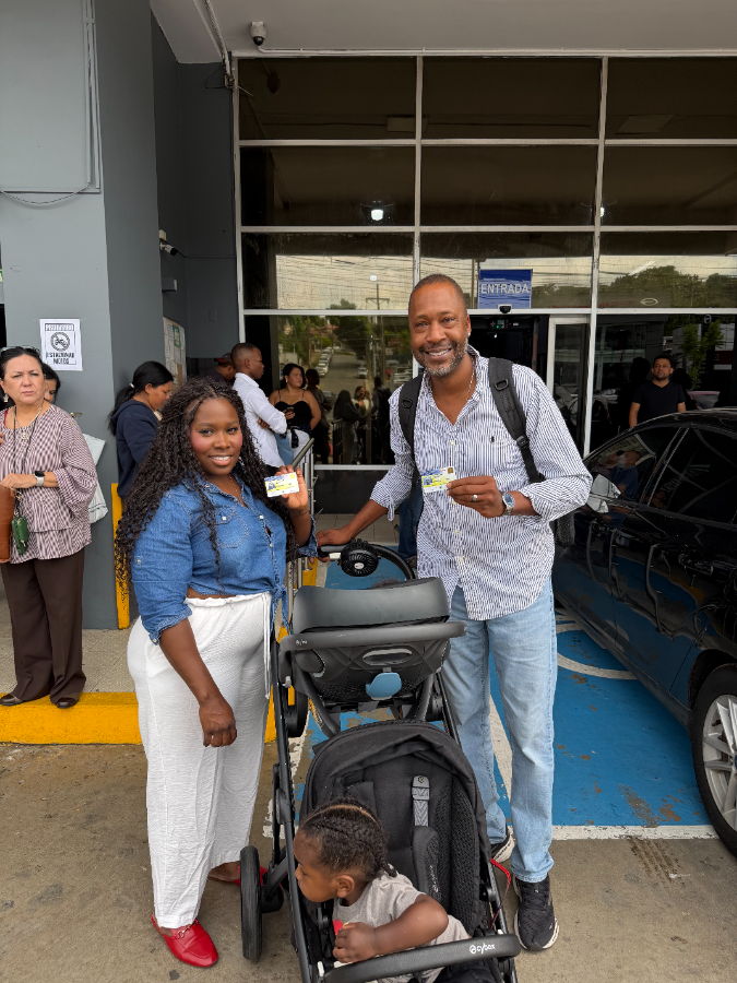A veteran family outside Panama immigration with their residency cards